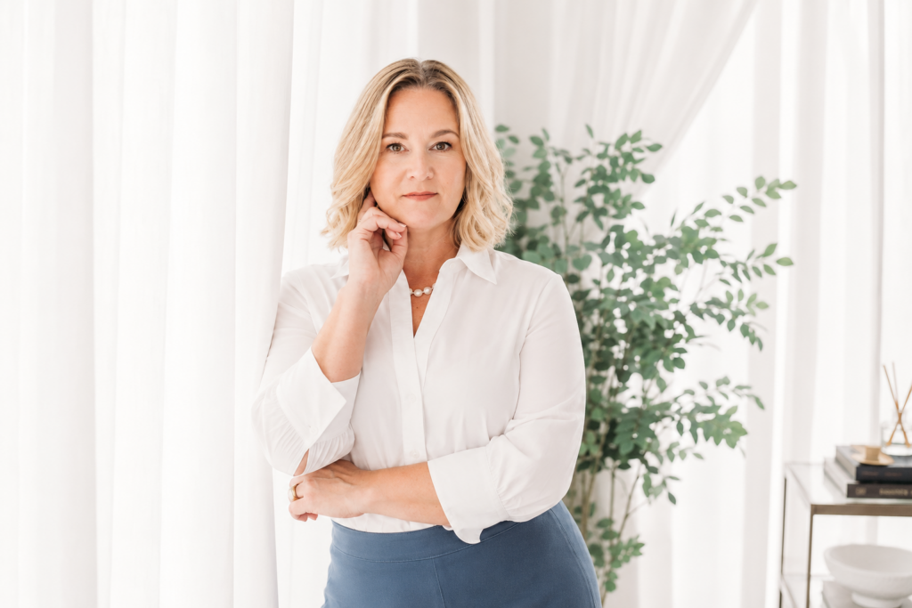 Professional social media marketing manager standing thoughtfully in a modern office setup, representing Inner Loop Media's social media services
